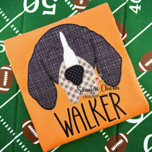 Embroidered patch of a dog with 'Walker' on an orange background, on a sports-themed fabric.